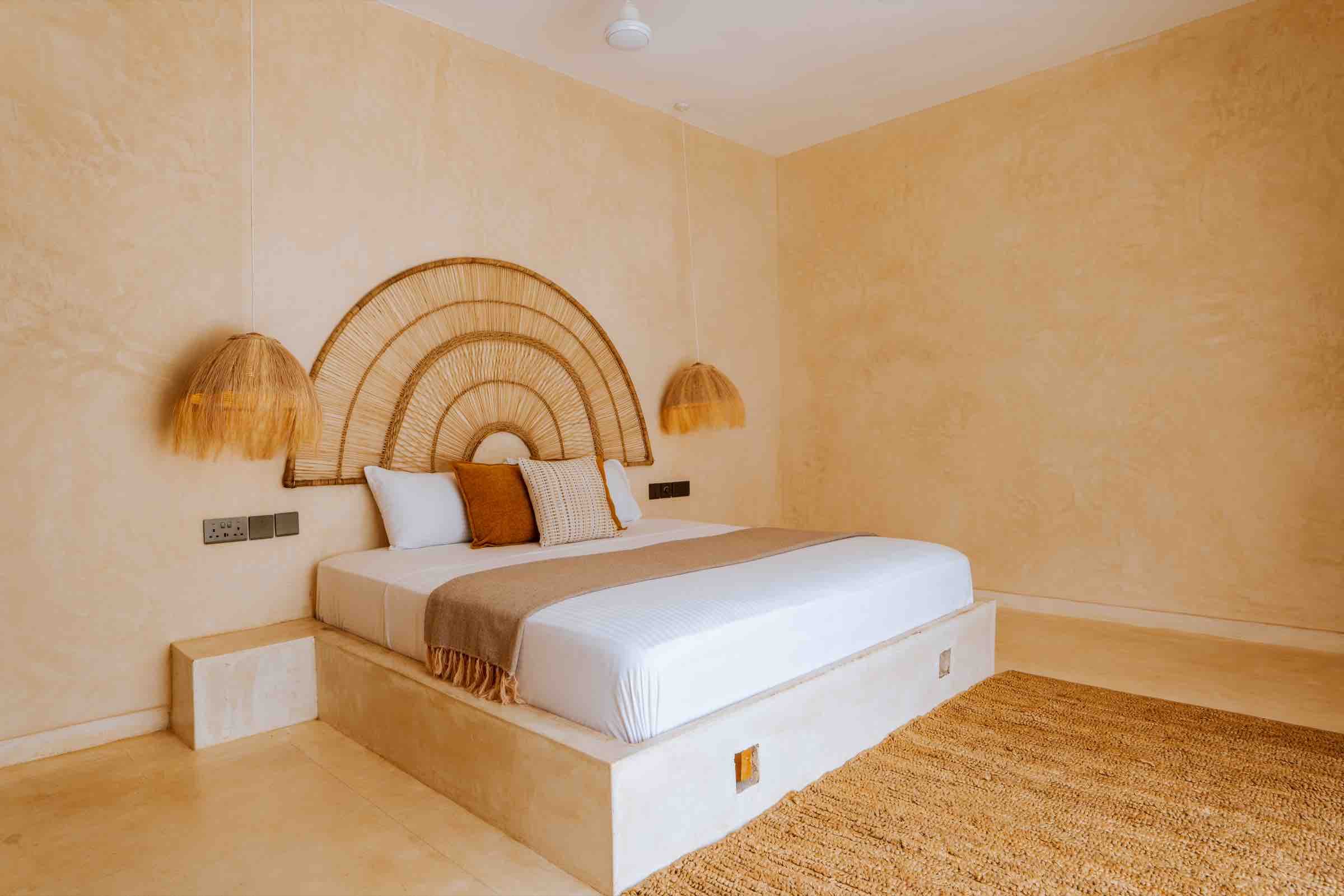 King bed with arched rattan headboard