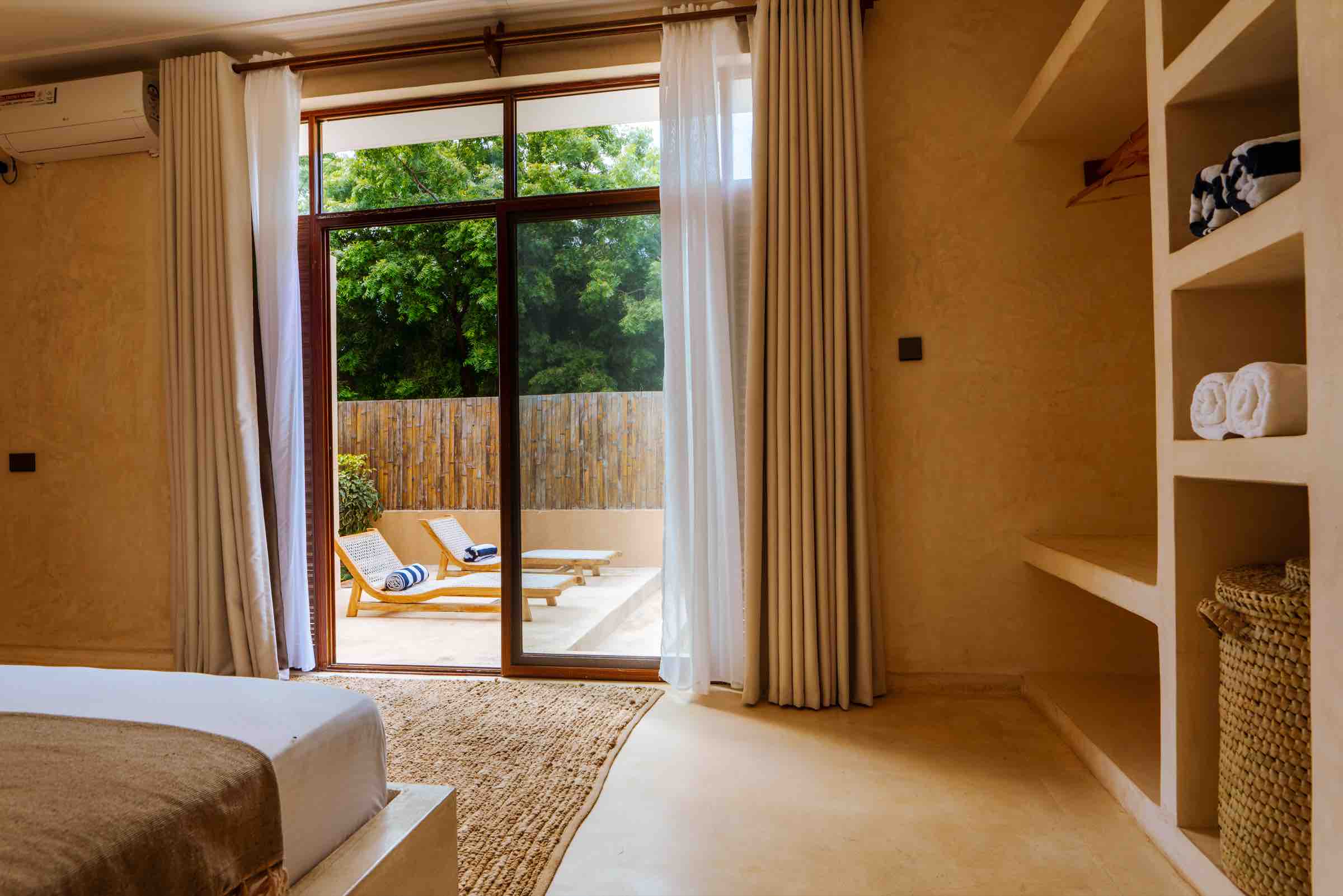Glass doors opening to pool deck with loungers