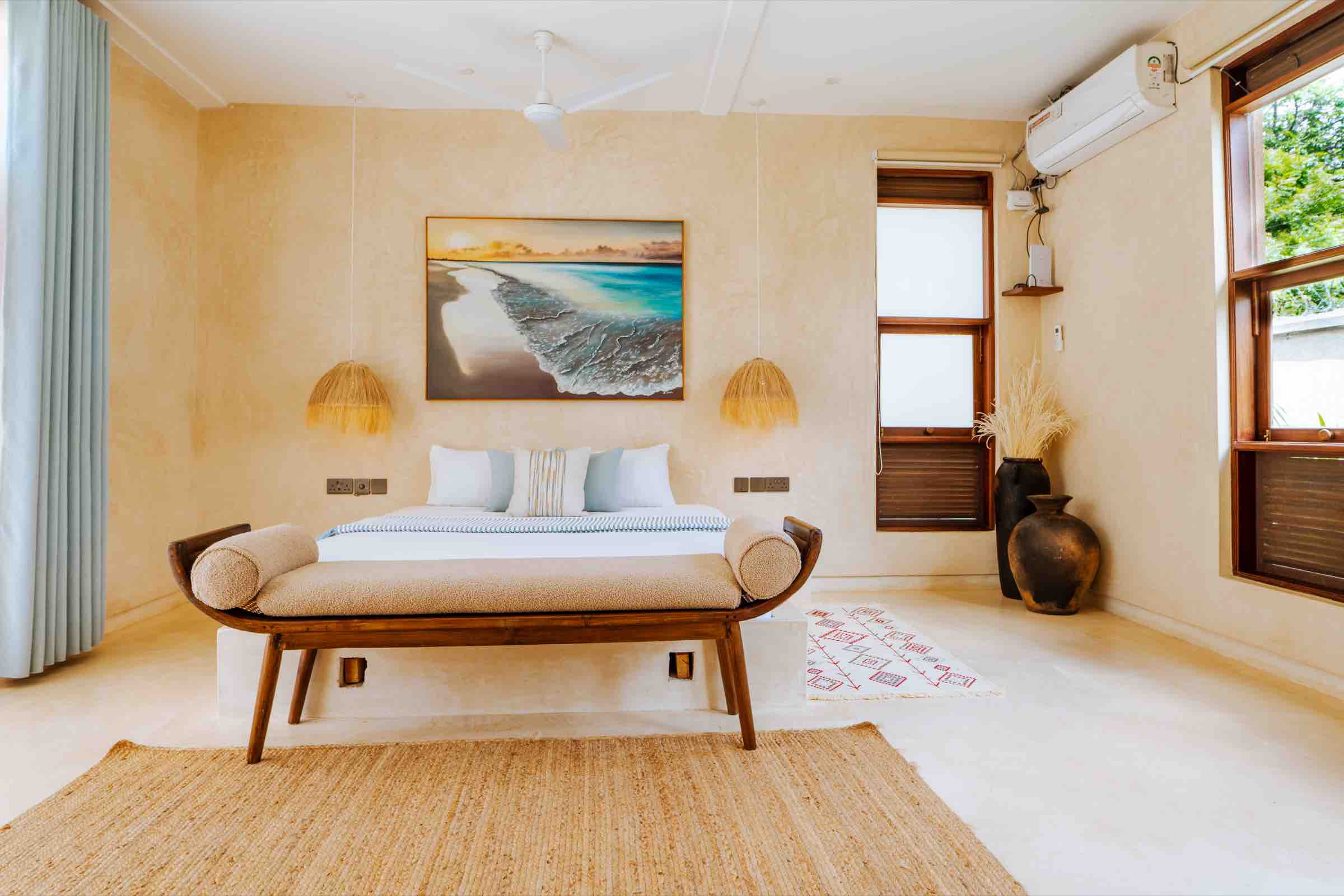 King bed with coastal artwork above