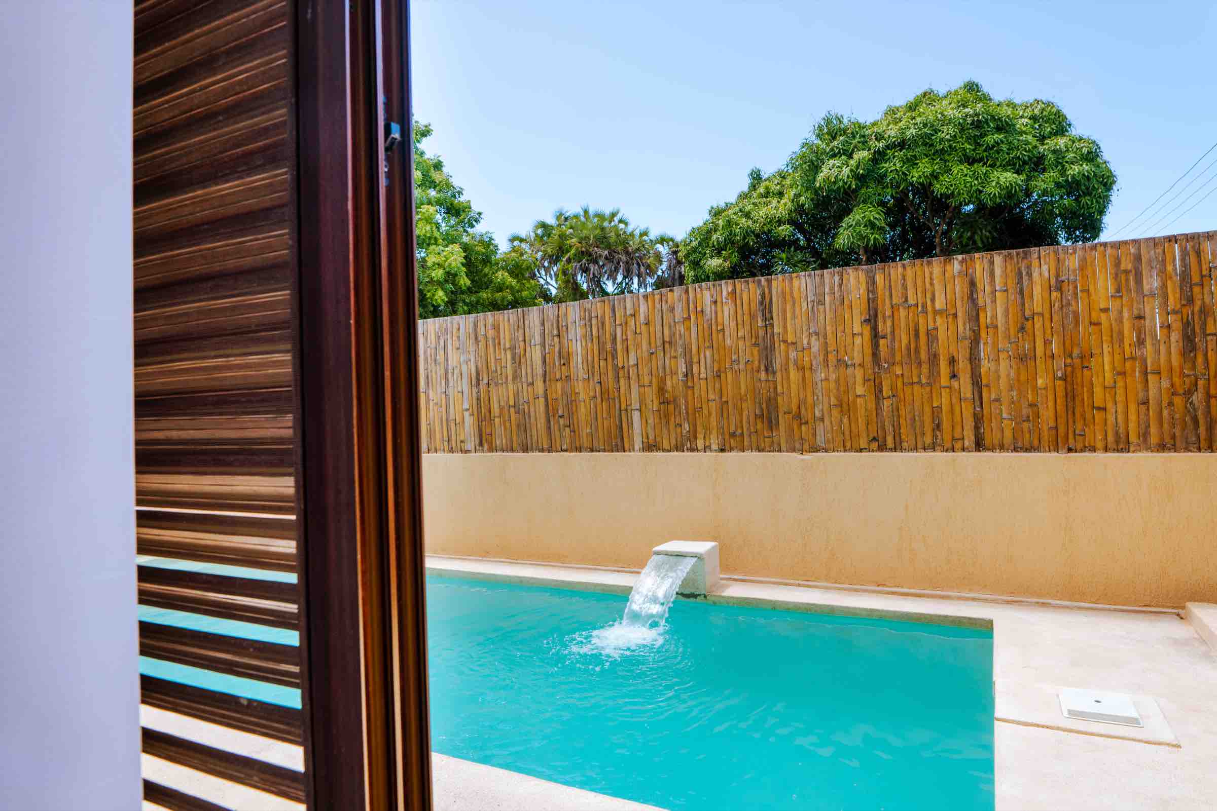 Louvered shutters opening onto the pool