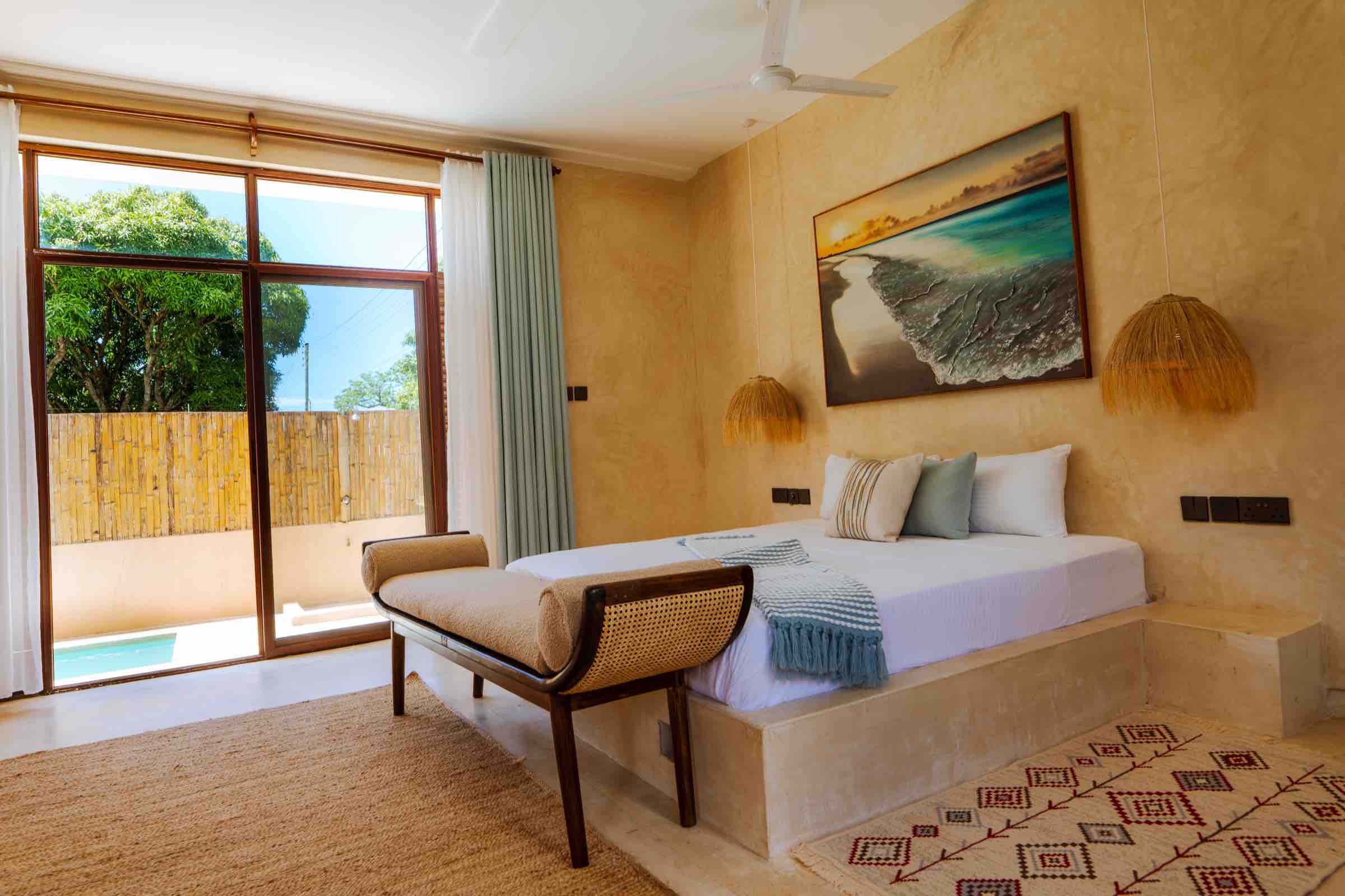 Pool view through glass doors with daybed